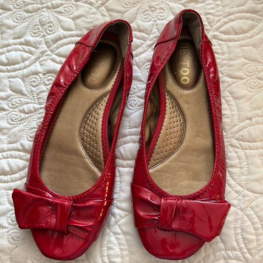 Me too shoes red patent leather with one foot bed kinda peeling .